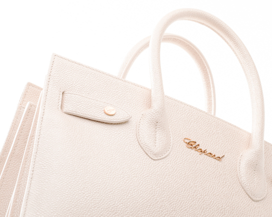 Luxury Chopard handbag photographed with soft high-key studio lighting for high-end fashion accessory photography.
